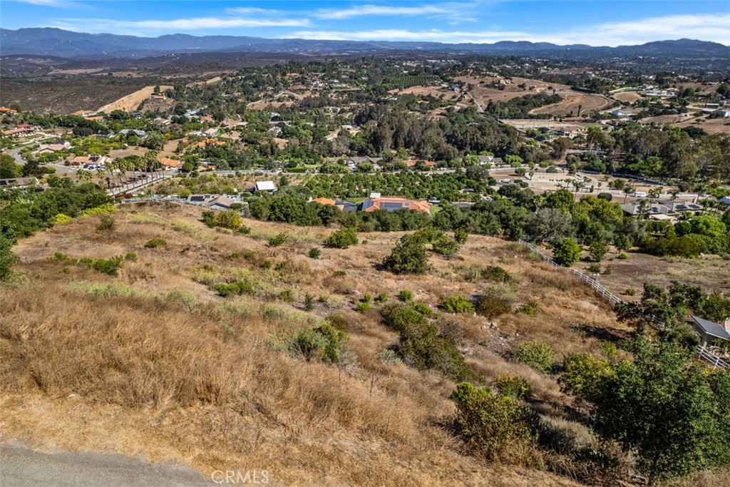 Discover 2.57 acres of stunning hillside land in the highly desirable Morro Hills neighborhood of Oceanside, San Diego County. This unique residential parcel offers endless possibilities to bring your dream home to life. Set amidst rolling hills and natural beauty, the property provides both privacy and breathtaking views while still being conveniently located near shopping, dining, and attractions. With ample space for custom design, gardens, outdoor living, or even a small hobby farm, this land invites you to create the lifestyle you’ve always envisioned. A rare opportunity to build in one of North County’s most sought-after communities!
