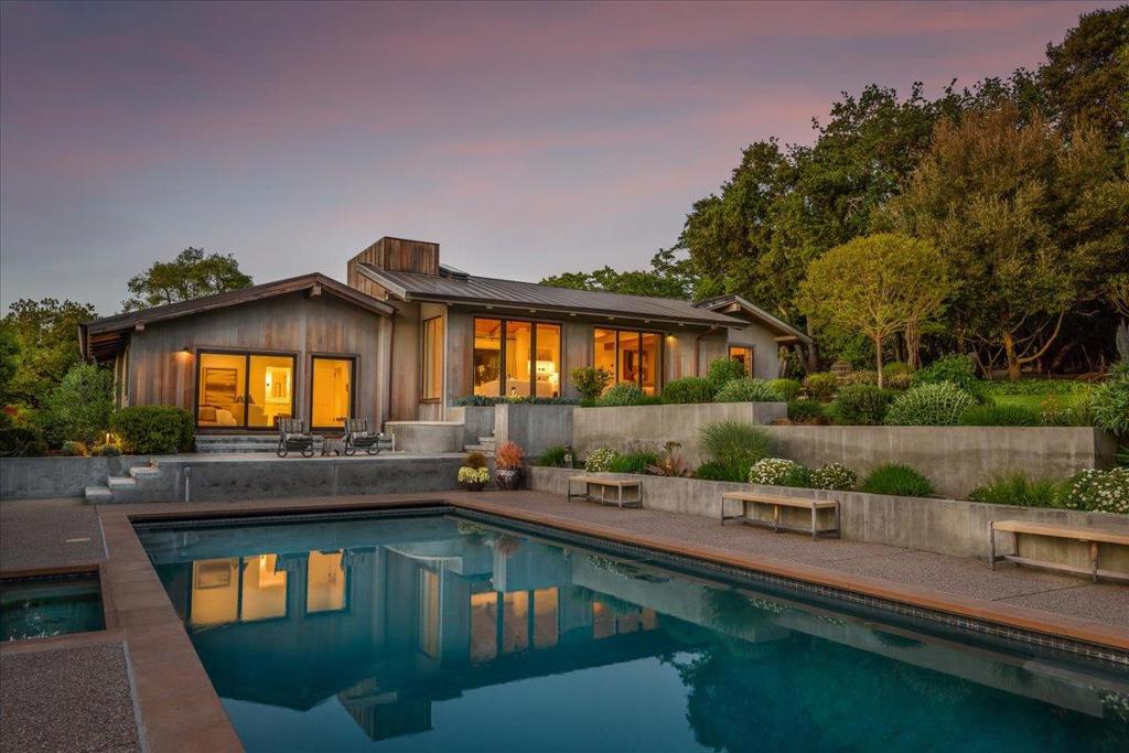 In Portola Valleys most coveted Westridge corridor, this striking property captures iconic Windy Hill views from its setting on more than 2 acres. The grounds unfold with California splendor sweeping level lawns, meandering garden paths amid native plantings, and a resort-style pool and spa perfectly oriented to Windy Hill. Inside, the home stuns with cathedral ceilings richly paneled in wood and white oak floors that span the open, multi-level floor plan designed for flow and functionality. Expanses of glass at every turn bring in the light, the landscape, and the views, creating a seamless connection to the outdoors. The living, dining, and family rooms flow off the chefs kitchen, which is highlighted by a commercial-quality AGA range. The primary suite is privately located, three bedrooms and two baths are in a separate wing, plus there is a gym with outside sauna. A rare and captivating retreat in one of Portola Valleys most exclusive locations.
