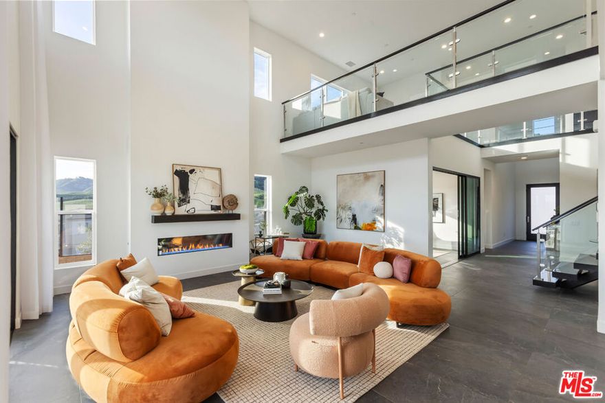 WALK INTO INSTANT EQUITY - recently appraised at $3.25M, this show stopping estate is now listed below value, presenting a rare chance to own one of Porter Ranch's finest homes. PANORAMIC UNOBSTRUCTED VIEWS, LARGEST LOT SIZE in the entire development, and PRIVACY, PRIVACY, PRIVACY 20668 W Hummingbird Ct checks every box. Nestled on a 0.75-acre lot, this fully customized 5-bedroom, 5.5-bathroom residence blends modern sophistication with California indoor-outdoor living.The heart of the home is built for entertaining: a double-wide Blue Ijen Quartzite waterfall island anchors the chef's kitchen, complete with top-tier appliancesWolf 6-burner range, SubZero fridge, premium dishwasher, trash compactor, high-speed hood and elegant Kohler fixtures with a lifetime warranty. Premium soft-close cabinetry, integrated smart systems, and panoramic sliding doors create seamless function and design.Every inch of the ENTIRE HOUSE IS UPGRADED: floating staircase, custom sound system inside and out, light automation, prewired bedrooms, high-end security with cameras, and premium finishes throughout. Main spaces feature sleek porcelain tile, while all bedrooms boast rich hardwood floors. Each ensuite bathroom is wrapped in stone or marble for a five-star feel.With a downstairs guest suite, a large home office with upgraded sliders, and a 110-ft private driveway this layout is flexible and future-proof. Whether you're sipping morning coffee from the private primary balcony or enjoying sunset dinners with doors wide open, this home was designed to embrace its stunning surroundings.Don't miss this rare opportunity to own an estate that truly redefines luxury, space, and privacy in Porter Ranch. Property available for lease at $10,995.
