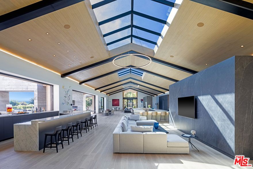 This luxurious zero carbon home is set on a commanding 2.48 acre lushly landscaped blufftop with amazing whitewater ocean views, total privacy and security.  On this remarkable and magical ranch estate you can fall asleep and wake up to the tranquil sound of waves, birdsong and the wind rustling through the property's over 300 trees.  The estate, one of just 17 properties located in the exclusive 80-acre MariSol Malibu community, is an award-winning, Doug Burdge designed modern ranch home that is 100% electric, featuring Tesla batteries, solar panels, and EV charging.  Known as Zero One, it is the first Zero Carbon Ready Certified home in California as designated by the ILFI, producing zero carbon emissions, operating or embodied.  The gourmet chef's and main kitchen is appointed with Miele appliances, Caesarstone countertops, and FSC-certified American white oak floors.  Adjacent to the kitchen is a Tuscan themed garden and outdoor dining pavilion set within a professionally maintained organic fruit orchard and vegetable/herb garden pollinated by on-site beehives.  The 4,250 sqft great hall is ideal for entertaining and exemplifies indoor/outdoor living with soaring 20-foot tall, FSC-certified Accoya ceilings, expansive skylights, a bar with a quartz waterfall countertop, and two refrigerated wine rooms.  Wellness elements include a fully stocked gym, water filtration system and a hospital-grade Merv 13 ventilation system to ensure clean filtered air at all times.  The Josh.ai voice activated control system and Zoom room will make daily choirs and business meetings a breeze.  Outdoor amenities include a heated saltwater pool, a spacious lawn, basketball court, bocce ball, golf greens and driving range.  The estate is move-in perfect with comfortable modern furniture, curated paintings from local Los Angeles artists, and two years of estate maintenance. Don't miss out on this carbon-conscious, luxurious, ocean view beach house and schedule a private tour today!