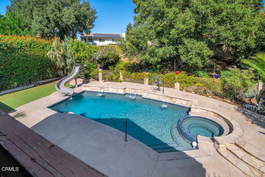 Discover this stunning tranquil sanctuary four-bedroom, three-bath home boasting over 2,800 square feet of beautifully crafted and thoughtful living space in the highly sought-after Green Knolls community of Thousand Oaks. Perfectly situated minutes from the park, Oaks mall, grocery store, hiking & biking trails, equestrian facility and 101 freeway. From the moment you arrive to the stunning residence you are greeted by the attentive private curb appeal with beautifully designed garage doors, a charming courtyard, a statement front door leading to a peaceful atrium--it's the most serene welcome to your private oasis. Inside, you'll find state of the art hard wood flooring, a beautifully crafted atrium, a wide elegant and sleek staircase with dramatic impression. The chef's kitchen is incredible, featuring five-star stainless steel appliances, a large custom island, marble countertops, waterpot filler at the stove, seamlessly connected to the formal dining area.Step inside the living room and great room with a spectacular fireplace and gorgeous vaulted ceilings, the perfect space for entertaining or cozy intimate family evenings in. Just beyond that is the downstairs bedroom and bathroom that has it's own private entrance making it the perfect space for your out of town guests or in home office. Spacious bedrooms can be found  upstairs along with an upgraded bathroom that ensure comfort for family and guests alike, while the primary suite serves as a true sanctuary complete with a cozy fireplace and balcony that overlooks your incredible backyard. This newly upgraded suite features a spa-inspired shower with sunken bathtub  as  well as a closet system offering never-ending space. Throughout, you'll find fresh painted walls, newlySEER upgraded A/C and heater with whole house attic fans creating an airy ambiance. Step outside to your quiet, private backyard retreat- complete with a stunning pool and waterfall, sparking spa, and lush landscaping. This home is ideal for hosting  gatherings that are unforgettable or enjoying intimate peaceful evenings with your loved ones. 26 Greenmeadow is truly one of a kind that has it all- location,  function, beautiful custom upgrades and incredible floorplan all in the heart of Thousand Oaks.