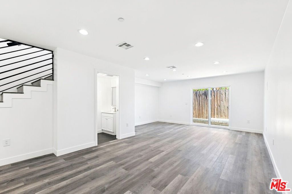 For rent this brand new 2BR townhome in the middle of the four-unit building complex, completed in 2024, with an open living and dining area defined by large windows that bring in plenty of daylight. The kitchen features a quartz waterfall island, stainless-steel appliances, and a simple subway-tile backsplash. The primary bedroom includes an en-suite bathroom with a dual sink and a glass shower over the bathtub, and a walk-in closet. The two additional bedrooms share a full bathroom. A powder room on the main level adds convenience, and throughout the home, you'll find luxury vinyl plank floors, central air, and an in-unit washer and dryer. Parking is in a secure, gated garage, and this home comes with 2 assigned garage spaces. Located on Sherman Way in Van Nuys, you're within walking distance of local cafes, shops, and parks with playgrounds. Easy connections to the 405 and 101 freeways. For more information or to arrange a viewing, call or text Mark.