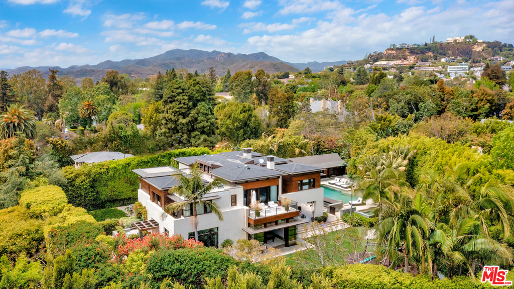 Situated on one of Pacific Palisades premier streets, this ultra-private, contemporary retreat showcases masterful craftsmanship and exceptional amenities. Surrounded by lush landscaping, the Zen-inspired, .68-acre estate is among the most spacious homesites in Upper Riviera. Envisioned by Grant Kirkpatrick of KAA Design, the 13,508-sq-ft residence boasts an open-plan living and entertaining spaces, artful details and a central atrium with 35 mahogany ceilings. Bathed in natural light, living, dining and family rooms leadto the magnificent chefs kitchen and expansive resort-style backyard with a pool, spa, waterfall, koi pond and Lanai with alfresco dining and lounging terraces. Amenities include a game room, bar, office, gym, media room, staff quarters and wine room. 7 bedroomsinclude the stunning primary suite with dual dressing rooms and spa-style bath. Offering absolute privacy and serenity, the home is located moments from The Palisades Village and The Riviera Country Club.