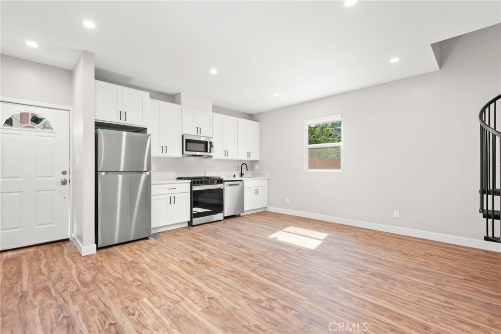 SECTION 8 AND HOUSING VOUCHERS WELCOME! Experience modern urban living at 145 E 36th Pl in this a NEWLY CONSTRUCTED residence featuring a bright open layout, stylish white-shaker kitchen with quartz counters and stainless-steel appliances, warm wood-style floors, and a striking black spiral staircase. Enjoy private outdoor space with brick-paver patio and secure fencing, all within minutes of Downtown LA, USC, and major freeways. This ADU is walking distance to Superior Grocers with convenient access to Metro bus lines and the 110 Freeway.