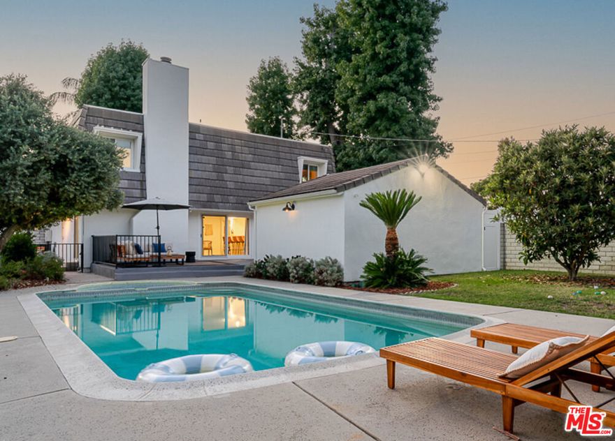 Fresh on the market. Ideally located In the sought after Millikan Area of Sherman Oaks is this very aesthetic and spacious French + Modern style Family Home. Spanning a large corner lot with a handsome white fence, large green trees and sparkling blue pool, this picture perfect home with character mansard style roof has been thoughtfully updated and modernized an all marks. The main level opens into an expansive and cozy living + family room with a fireplace, recessed lighting and large sliding glass doors that perfectly preview the green backyard and pool. Large galley style kitchen with open concept oversized bar contrasts warmly with golden wood cabinets, white quartz countertops, and new vertical stacked tile backsplash with a stainless steel appliance portfolio that flows into the dining room. First floor also offers a bedroom which can also play as an office space or recording studio. Leading your way to the upper level, fully outfitted with brand new oak floors and carpeted stairs you're welcomed to the large main landing which is ideal as a second family room, larger office or a just perfect play area ready for kids to hangout. Truly, a great design choice by having all 3 bedrooms on one level, the large primary bedroom has an abundant amount of closet space and built in cabinets. Primary bathroom also updated with new dual sink vanity and light fixtures with a large glass encased shower and spa tub. 2 other smaller bedrooms share a nice jack + jill bathroom and have tons of natural light through its brand new windows. The backyard is a true family's dream with a large pool and spa spotted with smaller areas to hang and bbq, play a game of soccer on the grass or just soak in the summer sunsets or moonlit winter nights. Greenbush has had all systems updated including new HVAC system, new pool heater + pump, new plumbing, new gas line, some updated electrical, new astro turf + brand new owned solar panels for efficiency. Situated in the desirable Millikan Middle School District, this home is close to shops, restaurants and supermarkets. Everything you need in a home in the best nook of Sherman Oaks.... Come take a look