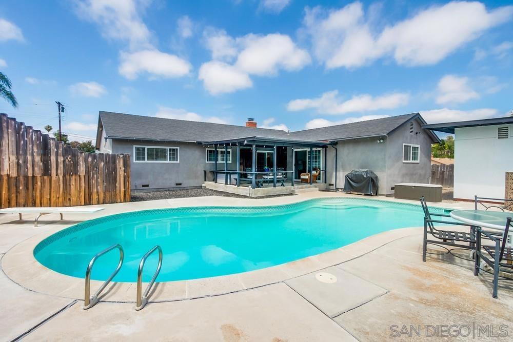 Welcome to 1438 Moon Rd! This spacious single-level home in Vista offers an ideal blend of comfort, flexibility, and functional upgrades. Featuring two primary suites, one of which is a spacious permitted addition with a private entrance and kitchenette hookup potential - the layout is perfect for multigenerational living, guest quarters, or future ADU conversion. Several updates have already been completed, including modernized bathrooms, open kitchen with stainless appliances, updated garage door and tankless water heater. Original hardwood floors are exposed in living room and the seller notes they continue under the carpet in the hallway and bedrooms, offering an easy opportunity to restore timeless wood flooring. The home is clad in durable concrete siding that helps with energy efficiency and reduced maintenance. Outside, the private backyard features fantastic ocean breezes, sparkling in-ground pool, a hot tub that conveys as-is, covered patio, and a detached 17-by-10-foot bonus structure with plumbing and electrical—perfect for a studio, office, or workshop (not included in overall square footage). A dedicated RV parking area accommodates up to a 40+ foot vehicle and includes 220V power and multiple exterior cleanouts. Additional features include low maintenance landscaping, a newer roof estimated at five years old, and a prime location walkable to Grapevine elementary school, sheriff substation and within minutes to the 78 freeway for easy to commute both to the 5 or 15. This home is move-in ready with room to grow and adapt to your needs.