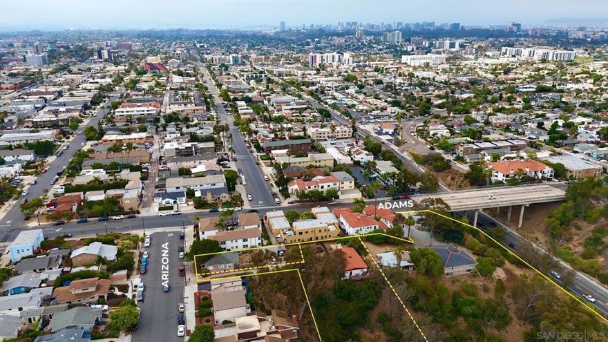 Rarely available 2.6-acre infill site in the heart of University Heights — fully occupied and income-producing with major development potential. Located at 2436 Adams Ave, this oversized parcel sits along one of San Diego’s most walkable, amenity-rich corridors, making it an ideal candidate for townhome or multifamily development.  The property is currently improved with a remodeled 4-unit configuration: a detached 4BD/4BA home and a three-unit, two-story building of 2BD/2BA units — generating $15,900/month in rental income. All units are updated and leased, providing immediate cash flow during entitlement or planning.  Plans for 18 two-story townhomes have already been submitted to the City, saving valuable time in the development process. RM-2-5 zoning under the Complete Communities Overlay increases FAR, density, and reduces parking constraints. Additional land zoned RM-1-1 provides flexibility for future concepts.  Developers and investors may purchase this property on its own or combine it with adjacent Arizona Street parcels (also available) to create a 3.14-acre multi-phase project totaling 43 proposed units.  This is a rare opportunity to control scale, collect income, and unlock long-term value in one of San Diego’s most sought-after urban neighborhoods.