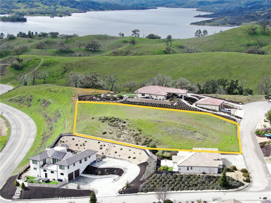 Stunning Lake View Parcel with Building Plans in Gated Heritage Ranch.
Situated above a peaceful cul-de-sac in the exclusive Lakeside Village enclave of Heritage Ranch, this premium 0.9-acre parcel offers views of Lake Nacimiento and a large flat building pad; an ideal canvas for your dream lake retreat.
The property comes with architectural plans approved by the Heritage Ranch Architectural & Environmental Committee and currently in the permitting process with the county. The proposed design features an impressive 4,772 sq. ft. residence with 4 bedrooms, 5.5 bathrooms, a media room, bar, home office, and expansive great room. The tall ceilings, large windows, and glass patio doors open up to a serene covered patio with an infinity-edge pool that captures wonderful lake views.
A wide driveway approach allows easy access into a 1,934 sq. ft. detached shop equipped with high-bay overhead doors, perfect for housing boats, recreational vehicles, and lake toys. There is a bonus a second-story loft providing lots of storage. Buyers may use the existing plans as-is or modify them to fit their personal vision.
Utilities are available at the lot line along the street frontage, offering a convenient head start for construction.
Enjoy all the premium amenities of the Heritage Ranch gated community, including:
*Private marina and boat launch ramps.
*24-hour guarded entry and roving security.
*Two swimming pools, sport courts, and playgrounds.
*Equestrian center with riding trails (membership required).
Located just minutes from Oak Hill Market and only 20 minutes from the vibrant restaurants, shops, and wineries of downtown Paso Robles, this property blends lake life serenity with Central Coast charm.
Don’t miss this unique opportunity to build your custom estate in one of California’s most sought-after lake communities.