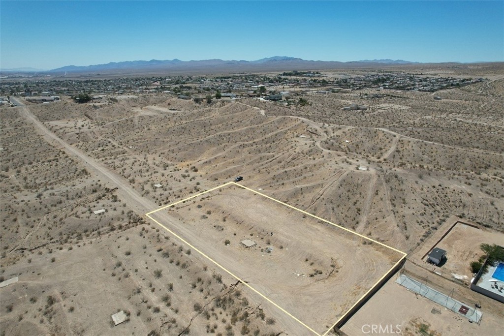 Great opportunity to own 1.25 acres of flat, buildable land in Barstow. Zoned residential with utilities nearby and homes all around, making it ideal for development. Located just off the 15 Freeway with easy access and only 10 minutes from the Barstow Outlets and local shopping. Dirt road access. Perfect for building a custom home or holding as a long-term investment. Affordable and well-positioned in a growing area. Buyer to verify zoning, utilities, and development requirements with the city.