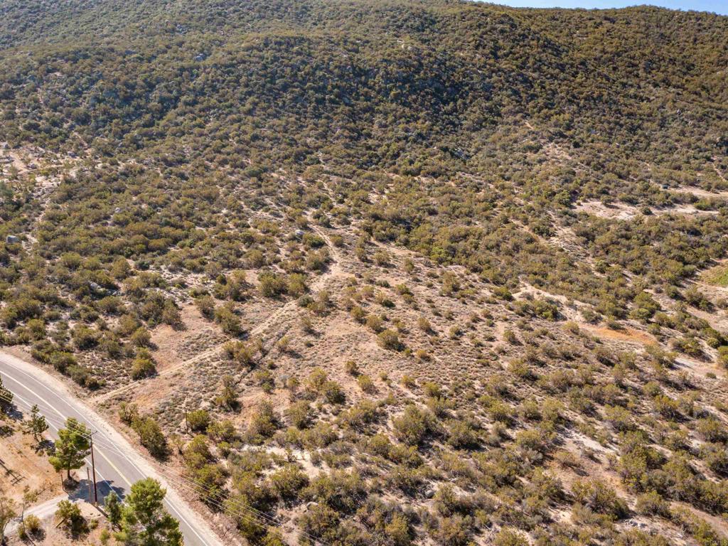 Positioned along the scenic North County Wine Trail, this nearly 25-acre parcel offers an exceptional opportunity to build your dream home in a region known for its natural beauty, boutique wineries, and tranquil lifestyle. With an existing well, power already installed, and a septic layout on file, much of the groundwork is complete for future development. The property enjoys convenient access while maintaining a sense of privacy, and is within walking distance to the celebrated Hawk Watch Winery—ideal for those who appreciate fine wine and quiet countryside living. The land itself is rich with character, featuring a blend of ribbonwood, native chaparral, and open grasslands. Gently rolling topography around the potential homesite includes unique natural pockets and panoramic views of surrounding mountains, valleys, and vineyards. The diverse terrain invites possibilities for equestrian use, hobby farming, or simply enjoying wide open space. With four gentle seasons, the setting supports year-round outdoor enjoyment and a wide variety of lifestyle visions. Outdoor enthusiasts will appreciate the nearby recreational offerings—hiking, horseback riding, and wildlife observation abound in the surrounding backcountry. You're just 45 minutes from the vibrant shopping and dining scene of Temecula, and about 1.5 hours from San Diego, providing a comfortable balance of rural serenity and urban convenience. A ready-to-build canvas in one of North County’s most picturesque and promising locations.