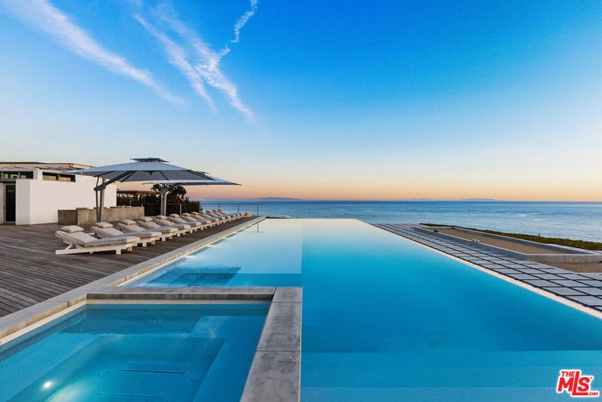Welcome to The Edge, the first offering at The Case, a private, 24-hour guard gated community of five newly constructed mid-century modern inspired estates perched above Malibu Colony Beach. On 2.6 acres, this new state of the art fully furnished turn-key blufftop architectural estate showcases masterful craftsmanship throughout its 5-bedroom, 8-bathroom 10,527 sq. ft. expanse. With 13' ceilings surrounded by walls of glass opening to the approx. 75' infinity edge, freshwater pool and the 10,000 sq. ft. wrap around Ipe wood deck featuring an outdoor kitchen and cabana, the home erases the line between indoor and outdoor living, ideal for the coveted Malibu lifestyle and the fulfillment of any entertainer's dream. This timeless retreat features solid teak finishings, including an oversized teak entrance door, signature hand-hewed, aged white oak floors and custom tiles and cabinets. The primary suite includes a sheltered 500 sq. ft. terrace creating a spa-like oasis and a bathroom with a period-correct terrazzo floor. Awe-inspiring unobstructed sunrise to sunset panoramic views, The Edge features curated custom and original Unvarnished furnishings, a bespoke Bulthaup chef's kitchen with Miele and Gaggenau appliances, an 800-plus bottle wine room, a state-of-the-art media room and an attached en-suite bonus room accessible through a separate, private entrance. Minutes from Malibu's world-class dining and shopping, the owner of The Edge, will be one of the fortunate five to experience an unparalleled lifestyle, in the most exclusive and never to be duplicated enclave on the California coast.