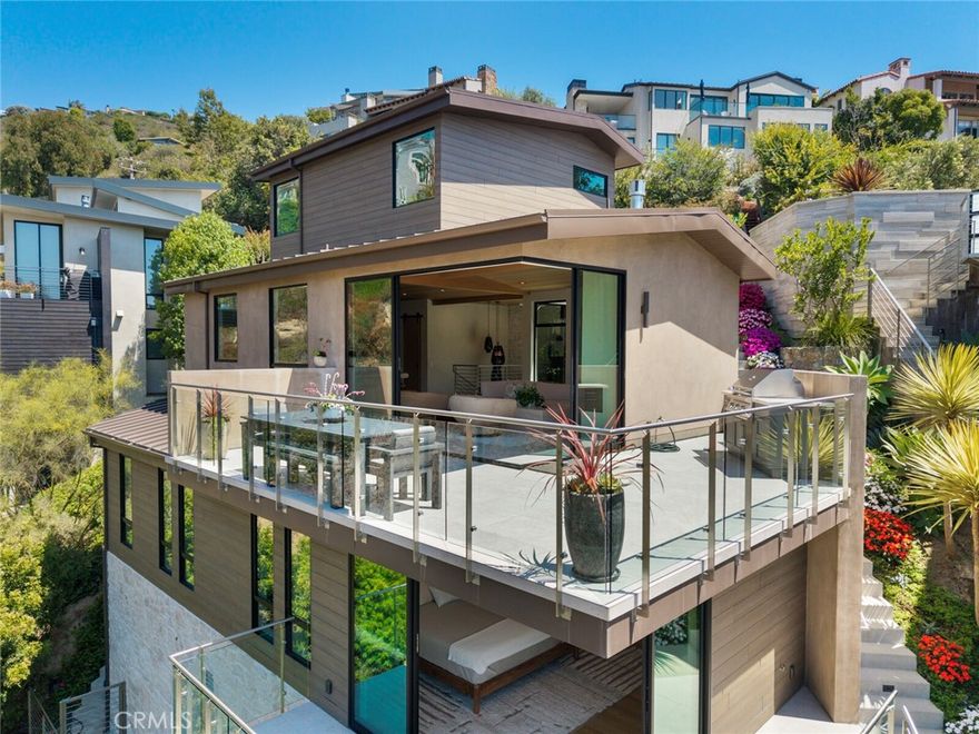 Brand New Contemporary Coastal Retreat with Ocean & Canyon Views

Completed in 2024, this striking contemporary coastal masterpiece blends style, sophistication, and seaside charm. Situated in Laguna Beach’s coveted Upper Diamond neighborhood, this approx. 2,500 sq ft, 3-bedroom, 3.5-bath architectural gem rests on a generous 8,000 sq ft lot, capturing ocean and canyon vistas from a serene, private setting—just minutes from the sand, acclaimed dining, and art galleries of Laguna Village.

Inside, sunlit open spaces showcase wide-plank white oak and designer tile flooring, with soothing oyster-hued Venetian plaster walls that complement stone counters and sleek European-style cabinetry. The state-of-the-art chef’s kitchen boasts a Wolf 8-burner range with dual ovens, 48" Sub-Zero refrigerator and freezer, additional beverage Sub-Zero in the island, Miele dishwasher, built-in espresso/coffee maker, Miele speed oven/microwave, Sub-Zero wine cabinet, and Scotsman ice maker—every culinary luxury at your fingertips.

The primary suite is a true sanctuary, featuring a private terrace with tranquil views, a spa-inspired bath, and a personal wet bar with Sub-Zero refrigerator. Thoughtful upgrades include solar panels, energy-efficient windows and doors, and an upgraded HVAC system for year-round comfort.

A 2-car garage plus dedicated golf cart garage provide ample parking and storage.

Outdoor living shines with a resort-style backyard, complete with a sparkling dipping pool and spa, spacious terraces, and an outdoor California room with privacy shades, built-in heaters, and a ceiling fan—perfect for year-round entertaining or peaceful sunset moments.

702 Diamond is more than a home—it’s a statement of contemporary coastal living at its finest.