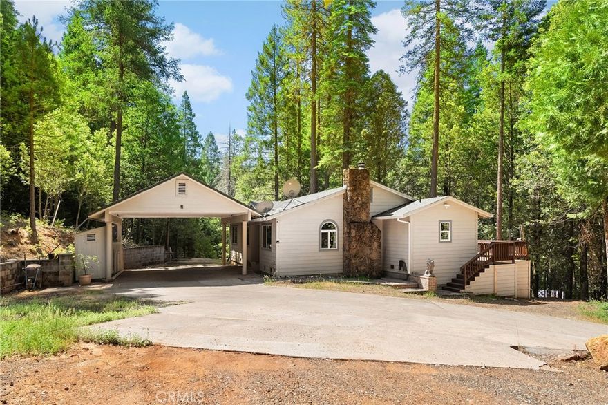 Peace and pines set on 2.24 serene acres in Magalia, this property blends natural beauty with practical upgrades. From the back deck, you can hear the gentle rush of the flumes, a peaceful reminder you're tucked into the best of mountain living.



Inside, you’ll find fresh paint, new carpet, and a hand-laid brick fireplace that anchors the living room with warmth and charm. The stunning fireplace is the kind of centerpiece that makes you want to light a fire, pour a cup of coffee, and stay a while. The layout includes generously sized bedrooms, a primary suite with its own bathroom, huge windows and plenty of storage throughout.



With a clear well and holding tank, clear termite report, detached workshop, covered carport, and a truly move-in-ready feel, this home offers comfort, space, and quiet simplicity surrounded by trees and fresh mountain air.