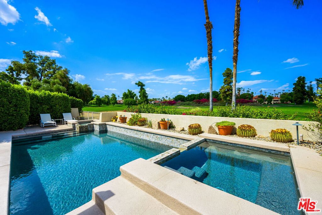 Stunning single-level remodeled home with gorgeous golf course views located in the highly desirable and guard gated Rancho Mirage Country Club. This turnkey residence has been beautifully designed to showcase a bright open floor plan with high ceilings throughout, abundant natural light and incredible indoor/outdoor living spaces. The main living area opens to the spectacular backyard featuring scenic golf course and mountain views, a beautiful pebble-tech pool, spa, built-in BBQ, dining area and multiple lounging spaces. The home features 3 bedrooms, 3 baths, large dining area with sliding glass doors, living room with centerpiece fireplace, large formal entry, high vaulted ceilings, beautiful exposed wood beams and automated blinds. The gourmet kitchen has been remodeled to showcase an oversized island with built-in seating, stainless steel appliances and incredible amounts of storage and counter space. The primary suite features a private enclosed patio, cedar lined walk-in closet and a spa-like bath with dual vanities, skylights and separate soaking tub. Attached two-car garage with additional storage, golf cart parking and fully-owned solar panels. HOA dues cover 24-hour security guard gate, cable TV, internet, roof, exterior paint and stucco, front yard landscaping, 4 community pools/spas and golf course. A truly move-in ready hideaway.