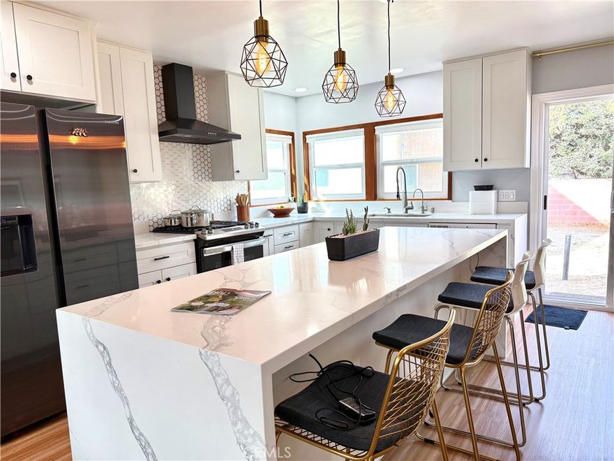 Great way to start the New Year! Look no further.  This substantially remodeled Single family home offers a wide open floor plan, recessed lights, a quartz waterfall countertops in the spacious kitchen and an abundance of light from every side!  New wood style flooring, newer kitchen quartz countertops, and newer cabinets.  Has fridge and stove.  Easy living as all this connects to the backyard through sliding glass doors. (Yard is divided with ADU in the back for privacyl  This home includes two generous sized bedrooms.  Use one as the main bedroom and the second for an office, guest room, or additional bedroom.  Easy access in the newly remodeled walk in shower, all with very tasteful hardware and accents. Complete with a Split A/C unit, washer /dryer, 1 car garage and an extra parking spot on the driveway.  Lovely neighborhood and the bonus is that it is not a through street!  It is a "Very Walkable" area with a Walk Score of 74. Great location with lovely Craftsman style homes. Located near Anaheim High School, Benjamin Franklin Elementary School, and an abundance of restaurants you can walk to including Villains Brewing Company and the Anaheim Packing District. Close enough to take in a game at the nearby Angel Stadium and short distance to Disneyland.  This very special property will not last long.  The home will be move in ready mid January so apply soon! (Home comes unfurnished). Make sure to watch the video.