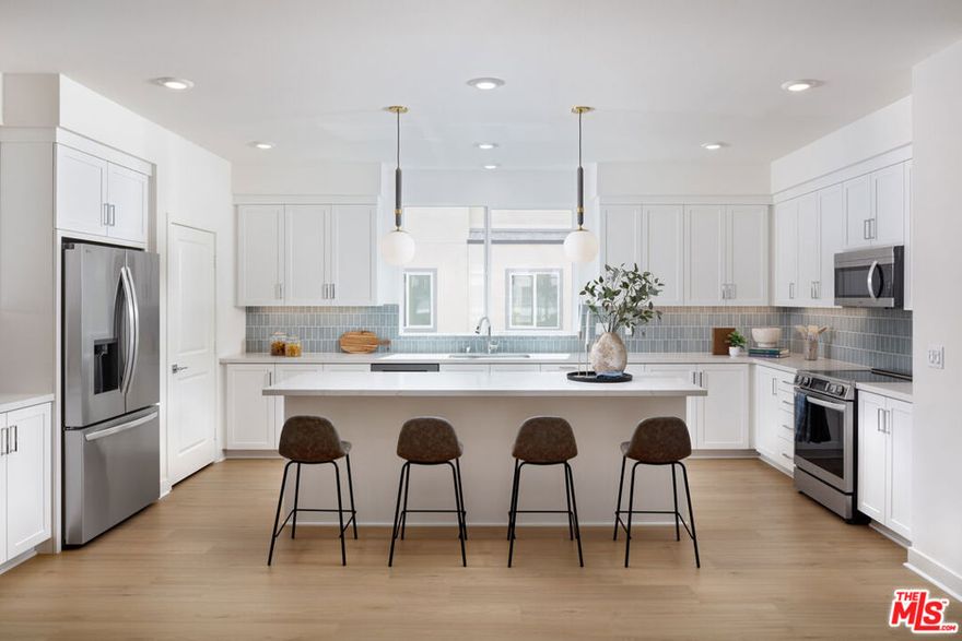 This three-story, all-electric Plan 1A home provides a versatile layout with an open main living level and private bedroom spaces above and below. The second level features an open-concept kitchen, dining, and living area that opens directly to a spacious deck, extending the living space outdoors and providing an ideal setting for dining, relaxing, or hosting. The gourmet kitchen is appointed with upgraded quartz countertops, a full tile backsplash, classic white shaker-style cabinets with undercabinet lighting, and an induction range. Matte black hardware is carried throughout the home for a cohesive finish. The third level includes a primary bedroom with walk-in closet and en-suite bath, along with two additional bedrooms, a full bath, and a conveniently located laundry area. A junior primary suite on the first floor provides flexibility for guests, extended family, or a home office. Flooring selections have not yet been finalized, offering buyers the opportunity to personalize their home at the Design Studio and choose finishes that reflect their individual style -- but only for a limited time! Located within The Heights at Ponte Vista in San Pedro, this Plan 1A home combines a well-planned layout, indoor-outdoor living, and the ability to customize select interior finishes prior to completion. Enjoy common area pool, spa, BBQ's, covered outdoor dining area, recreational trails, green space and so much more. This is the true Coastal Living experience you have been waiting for. Virtual tour and photography are of model home and used for representational purposes only.