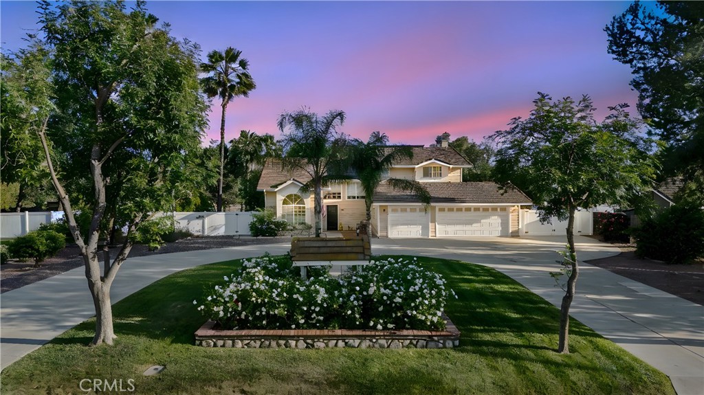 A Rare Menifee Masterpiece.
Welcome to the ultimate estate, peacefully located in a cul-de-sac within the highly sought-after J-Bar Ranch Community of Menifee. This stunning 1-acre estate blends elegance, functionality, and outdoor living—perfect for those craving space and serenity.
Arrive to a circular driveway and a charming wishing well framed by vibrant white florals. The front yard features mature apple, apricot, pear, and guava trees, plus young lime and grapefruit saplings.
Inside this 4-bedroom, 2.5-bathroom home, you’ll find a 3-car garage with keypad entry and fully paid-off solar. A dramatic entry showcases high ceilings and a sunken formal seating room—ideal as an office or quiet retreat.
The light, modern kitchen features granite countertops and opens to a cozy living space with wood-burning fireplace. Downstairs offers hardwood and tile flooring, and a large laundry room with sink and storage.
Upstairs are carpeted bedrooms with ceiling fans, including an impressive primary suite with double doors, accent wall, and sliding glass doors to a spacious balcony with a beautiful view of the property. It includes a walk-in closet with built-in shelves, a second closet, and an en-suite with granite countertops, dual sinks, and a tiled shower. Of the three additional bedrooms, one is generously oversized—ideal for a shared room, media space, or guest suite—while all offer comfort and natural light.
Outside, enjoy a newly refinished sports pool with new tile, a large covered patio, and a grassy lawn shaded by mature trees—ideal for pets or play. A fully fenced garden with irrigation is ready for your harvest.
A long driveway leads to a 1,450 sq ft workshop with two automatic garage doors, a full entertainment bar, reinforced storage room, pegboard tool wall, and separate electrical panel. Behind it are two 40-foot storage containers that provide ample space for all your toys and tools.
The lower portion of the property features a sandy beach area with fire pit and a striking hillside waterfall flowing into a 20' x 30' koi pond—home to koi, tilapia, turtles, and blooming lily pads. New pond equipment, including a UV filter, ensures a clear view of this serene living feature
This extraordinary estate is fully equipped with automated sprinkler systems across the grounds and garden and offers unparalleled amenities rarely found in one property. Whether you're seeking tranquility, entertaining space, or a functional homestead—this is the one.