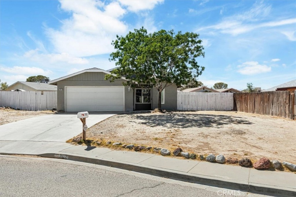 Welcome to 21021 Pippin Way a beautifully remodeled 3-bedroom, 2-bathroom home offering 1,900 sq ft of comfortable living space in the heart of California City. This light-filled home features an inviting open layout with ample natural light flowing through the main living areas. The updated kitchen comes fully equipped with appliances, generous cabinetry, and a convenient breakfast counter perfect for morning coffee or casual meals. Gather around the stunning fireplace in the cozy living room, ideal for relaxing evenings or entertaining guests. Beyond the main living space, enjoy the expansive backyard with a large covered patio—perfect for outdoor dining, entertaining, or simply relaxing under the California sky. A picturesque mature tree enhances the front yard, adding to the home's welcoming curb appeal. Additional features include a 2-car attached garage and modern finishes throughout, making this home truly move-in ready.