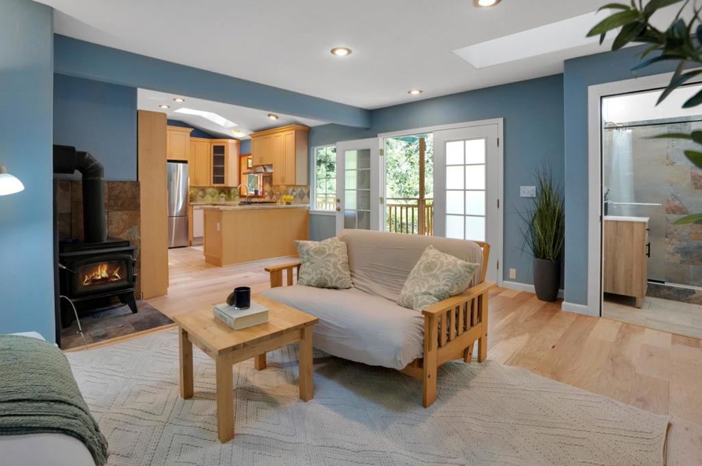 Welcome Home to the Tranquility of the Redwoods! Nestled among serene trees, this charming 3-bedroom, 2-bathroom home offers peaceful living with beautiful natural surroundings. Step inside to find hardwood flooring throughout and an abundance of natural light pouring in through skylights and large windows. Start your mornings on the front deck with a cup of coffee, soaking in the quiet beauty of the redwoods. The freshly painted exterior, interior, and deck provide a crisp, updated look, while the newly remodeled bathrooms add a modern touch. The spacious primary bedroom features treetop views and an ensuite bathroom for added comfort. With driveway parking for up to three vehicles, this cozy retreat is as practical as it is picturesque. Come see the redwoods retreat you've been waiting for, your peaceful escape awaits!