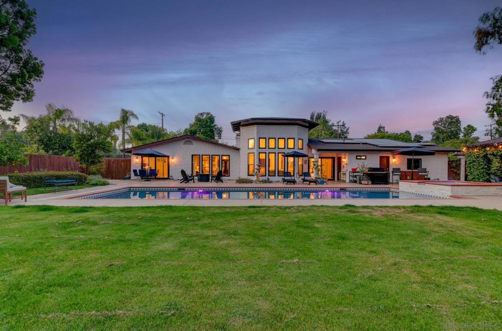 Beautifully reimagined single-story home in the heart of Poway! This 5 bed, 4.5 bath retreat features an open, light-filled layout with wide-plank LVP flooring, designer finishes, and fully updated kitchen and baths. Enjoy seamless indoor-outdoor living with a sparkling saltwater pool, new equipment, and a lush backyard orchard with apple, lime, lemon, orange, guava, peach, avocado, and grapevines. Major upgrades include: lifetime warranty windows (2023), 50-year roof & skylights (2022), interior/exterior paint (2022, 5-year warranty), full plumbing re-pipe (2022–2023), 2 AC units, 2 furnaces, tankless water heater, and water softener (2022), plus saltwater pool conversion (2023). Leased solar adds energy efficiency. This is Poway living at its finest modern, turnkey, and move-in ready. Don’t miss this rare opportunity!