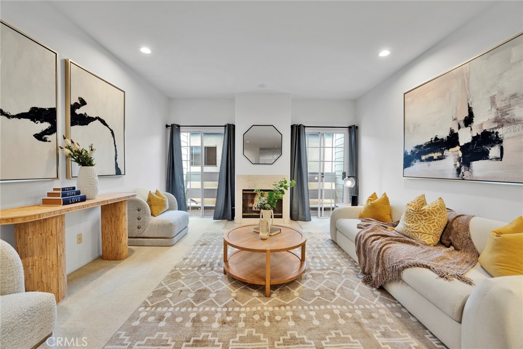 This condo is located on the second floor of the residential building, with the first floor designated as a ground-Level parking area, making daily living incredibly convenient. Most areas have just been repainted, and select fixtures have been upgraded to LED, creating a bright and modern living space.The spacious living room features a cozy fireplace, and on either side of the fireplace are floor-to-ceiling glass sliding doors that lead to the balcony, allowing for a seamless indoor-outdoor flow and plenty of natural light. The open-concept living area also includes a convenient bar area, perfect for enjoying coffee or cocktails. The kitchen is fully functional, ideal for everyday cooking needs.Both bedrooms are en-suite, each with its own private bathroom, ensuring maximum privacy. The unit is also equipped with central heating and air conditioning, in-unit laundry, and secure parking.The location is ideal, just a short walk to the vibrant Sawtelle Blvd dining and shopping area, and only minutes away from UCLA, Santa Monica, Brentwood, Century City, and Beverly Hills. This condo combines modern upgrades with an unbeatable location, making it the perfect West LA home.