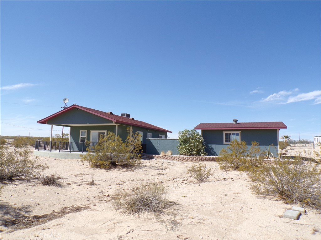 Desert Retreat on 2.5 Acres – Minutes from Joshua Tree National Park! Discover your peaceful escape in the heart of the Desert Heights area of 29 Palms. This charming 2-bedroom, 1-bath home offers cozy desert living with modern comforts. The home features an inviting interior with inside laundry, all-electric utilities, and HVAC for year-round comfort. Enjoy your morning coffee in the private courtyard or relax under the covered patio, taking in the serene desert views. A detached single-car garage provides extra storage or workshop space. Nestled on a fully fenced 2.5-acre lot, there’s plenty of room to roam, garden, or even expand. Just a short drive off a paved road and only minutes from the entrance to Joshua Tree National Park, this gem offers both convenience and seclusion. Whether you're looking for a full-time home, weekend retreat, or investment opportunity – this adorable desert home is ready to welcome you!