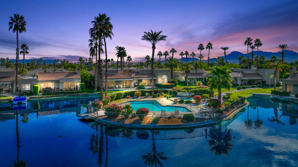 Lakefront Luxury in Prestigious Lake Mirage Racquet Club!! Welcome to desert lakefront living at its finest! This well appointed 2-bedroom, 3-bath condo is located in the prestigious Lake Mirage Racquet Club in the heart of Rancho Mirage. Enjoy tranquil lakefront views from the comfort of your fully furnished, move-in ready home.Designed for both comfort and entertaining, the spacious open floor plan features soaring ceilings, a double-sided fireplace warming both the living and dining areas, and a stylish wet bar perfect for hosting. The kitchen is outfitted with granite countertops, stainless appliances, and a pass-through sit-up bar ideal for casual dining.Shutters throughout allow for the perfect balance of natural light and privacy, while the two generously sized bedrooms each offer their own en-suite bath. Additional features include a third bathroom for guests, a convenient direct access two-car garage and new A/C unit.Relax on the patio with stunning water views and enjoy your private boat dock. Take advantage of the world-class amenities--pools, tennis, pickleball, fitness center, and clubhouse. Don't miss this rare opportunity to own a waterfront home in one of Rancho Mirage's most sought-after communities!