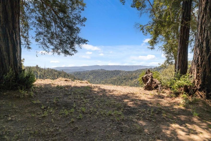 Welcome to Redwood Ridge Way, a whimsical hilltop retreat tucked away at the end of a private road. This sunny, south-facing 10-acre haven not only offers breathtaking panoramic views and glimpses of Monterey Bay, but it also invites you into a world of tranquility and inspiration.  For those passionate about permaculture, meditation, or yoga retreats, this property is a canvas for your lifestyle dreams. With a private well and reliable cell service, you get the best of both off-grid serenity and modern convenience. Whether you are seeking a private retreat, an artists sanctuary, or a space for wellness and mindful living, Redwood Ridge Way is ready to welcome you home.