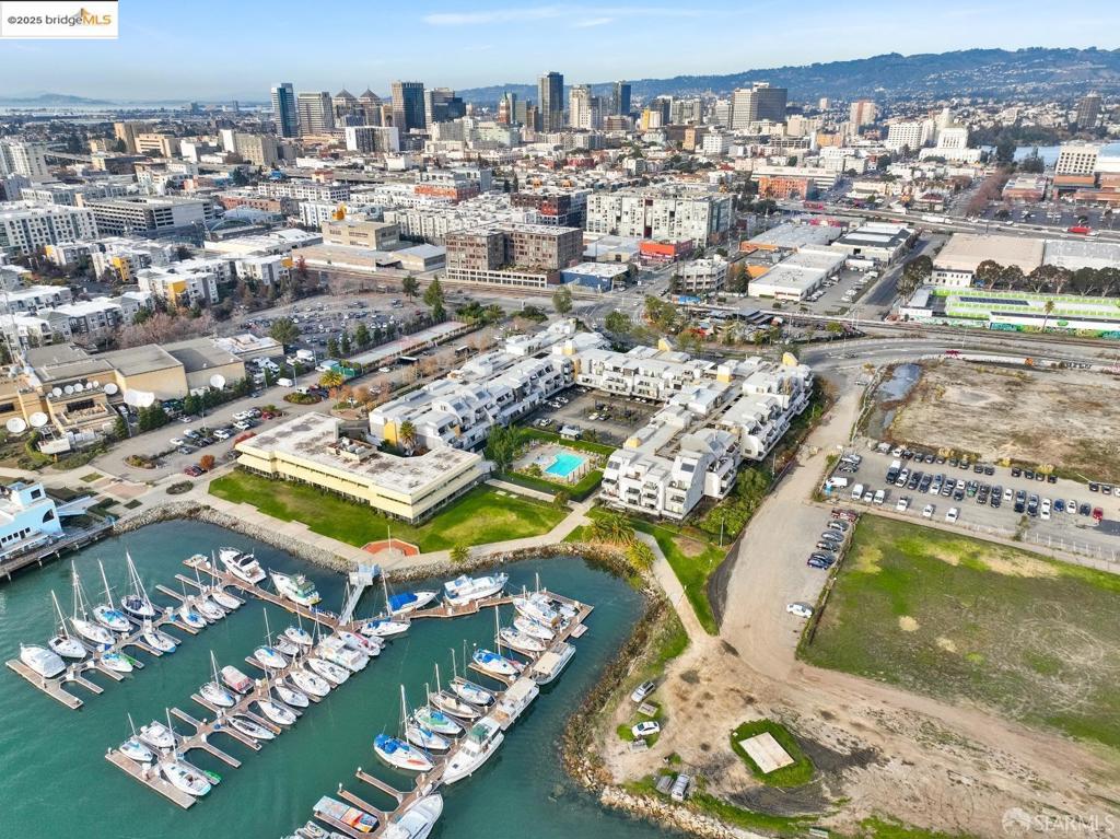 Step into the vibrant energy of Oakland's Jack London Square with this stylish and affordable starter condo perfectly located just steps from the marina and the scenic San Francisco Bay Trail. Bright 1-bed, 1-bath open floor plan condo with hardwood floors, stainless steel appliances, and a private balcony offering stunning marina and hill views. Located in the resort-style Portobello community, enjoy access to pool, hot tub, sauna, gym, tennis courts, clubhouse, and more. Includes 1 parking spot, concierge service, package lockers, bike storage, and night security. Pet-friendly and professionally managed with on-site staff. Steps from the SF Bay Trail and walking distance to Jack London Square's dining, shopping, and entertainment. Close to BART, Amtrak, ferry, and I-880 for easy commuting. Make an offer today, this gem won't last!