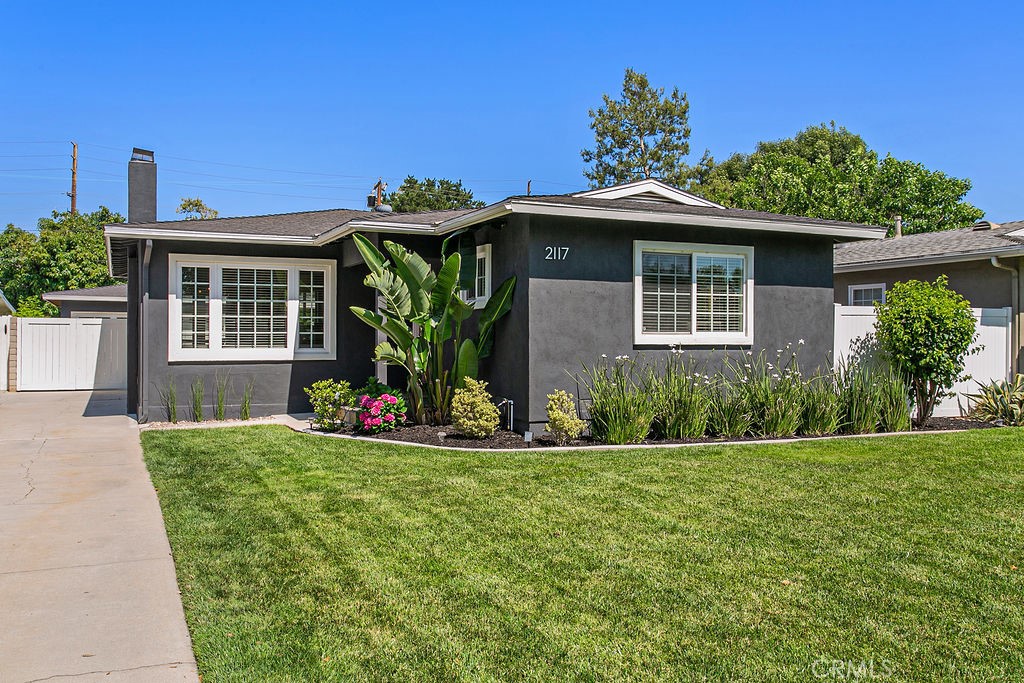 Located in the highly sought-after Park Santiago neighborhood, this beautifully updated single-level home offers 3 bedrooms,
2 bathrooms, and 1,445 square feet of stylish, comfortable living space. Situated on a quiet, tree-lined street just moments from Park
Santiago, local shopping and dining, and convenient access to the 5, 22, and 57 freeways, this home perfectly balances tranquility
and accessibility. Interior highlights include luxury vinyl plank flooring, crown moldings, and dual-pane windows throughout.
The spacious kitchen is appointed with granite countertops, stainless steel appliances, and a newer Bosch dishwasher. The primary
suite features a walk-in closet, direct access to the backyard, and a serene en suite bath with a jetted tub and separate shower.
Step outside to a newly landscaped backyard retreat, complete with fruit-bearing lemon and pomegranate trees along with olive and strawberry trees,
custom lighting, and a pergola-covered patio—ideal for relaxing or entertaining. A detached garage and a separate, finished office
shed with wired Ethernet offer excellent flexibility for remote work or creative projects. Additional upgrades include a
tankless water heater with recirculation, new sewer and gas lines, and a whole-house water filtration and softener system. Don’t
miss this rare opportunity to own a thoughtfully upgraded home in one of Santa Ana’s most cherished neighborhoods!