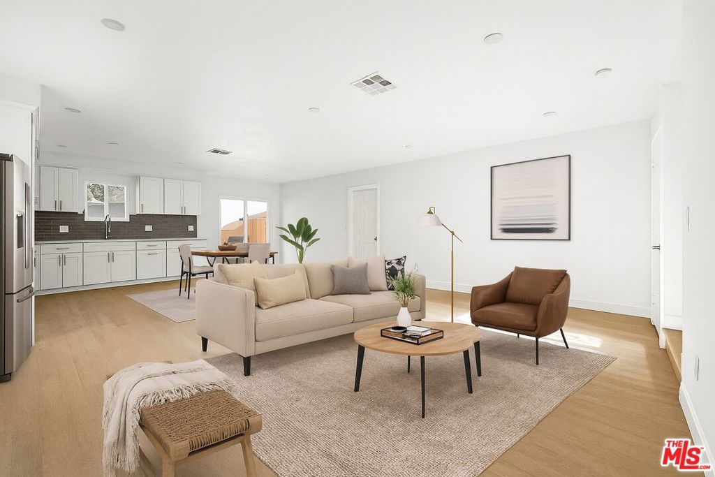 Built in 2019, this non-RSO triplex delivers an exceptional 7.6% CAP rate and flexibility for both investors and owner-occupants alike. The property is entirely exempt from state and local rent control regulations, providing rare freedom in setting rental terms and maximizing income potential. The front, stand-alone unit lives like a single-family home - freshly remodeled and delivered vacant, ready for an owner to move in or for immediate lease-up. This spacious unit offers approximately 1,700 sq. ft. of open-concept living space filled with natural light, featuring 4 bedrooms, 3 bathrooms, and a two-car attached garage. At the rear are two identical tenant-occupied units, each offering 1,561 sq. ft., 4 bedrooms, and 3 bathrooms, generating consistent and significant rental income. The total living area across all three units is over 4,800 sq. ft. with 12 bedrooms and 9 bathrooms. The hardscaped exterior provides ample parking and minimal maintenance, while separate gas, electricity, and water meters allow tenants to pay their own utilities, simplifying management and maximizing net income. For the sophisticated investor, there is an opportunity here for cost segregation to allow significant tax deductions and savings up-front, making this a no-brainer investment. Also a great opportunity for an owner-occupier to take advantage of Fannie Mae's new 5% down payment opportunity! Situated in an area benefiting from major infrastructure and economic growth ahead of the 2028 Olympic Games, the 2026 World Cup, and ongoing public transit expansion, this property offers not only strong current cash flow but also meaningful long-term appreciation potential.