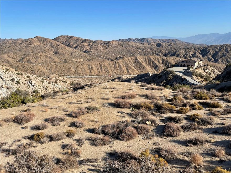 A rare opportunity to own one of Yucca Valley’s most breathtaking parcels—15 acres perched atop a dramatic canyon ridge with a city-approved build site and sweeping views of the desert valley below. Located on the edge of the desirable Country Club neighborhood in west Yucca Valley, Ridge Sky Hold offers a true “eagle’s nest” setting with panoramic vistas of Morongo Valley and snowcapped Mount San Gorgonio. This build-ready property comes with an approved variance, light grading, survey, soils testing, and a conceptual site plan—everything you need to hit the ground running. Whether you’re dreaming of a legacy estate or a standout vacation rental, this elevated lot—offering dramatic views and rare accessibility—is the perfect
canvas for a one-of-a-kind custom home. Seller potentially flexible on terms. Full marketing package available upon request.