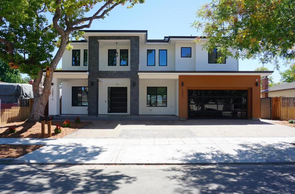 This stunning new construction offers approximately 5,700 sq. ft. of refined living, including a main residence (3,087 sq. ft.), an attached ADU (994 sq. ft.), and beautifully designed outdoor spaces including a front porch (285 sq. ft.), rear patio (371 sq. ft.), and balcony (371 sq. ft.). Over 1000 sqft attic storage space. The main level welcomes you with a grand 20-ft. foyer and a striking transparent glass staircase. It features a guest master suite, powder room, and an elegant living area with a dramatic two-story tile fireplace wall. The gourmet kitchen boasts Thermador appliances, a waterfall island, and direct access to the covered patio through expansive glass bi-fold doors for seamless indoor-outdoor living. Upstairs, the luxurious primary suite and two additional master bedrooms each offer spa-inspired baths with full-height tile, wall-mounted toilets, and custom cabinetry. The ADU provides two more master bedrooms.High-end finishes include AB-grade engineered oak floors, premium Milgard windows, LED lighting, and designer fixtures. A solar power system, premium security camera setup, and 2 EV chargers combine modern comfort with efficiency. Fully inspected, move-in ready, and backed by a comprehensive builders warranty under California SB 800.