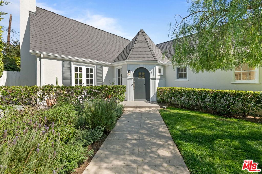 The Edwin L. Stanton Residence by Stanton, Reed & Hibbard (Hotel Figueroa DTLA). Located on a quiet, tree-lined street in the Windsor Square area (geohublacity.org) of Hancock Park, this gated English Cottage is steeped in charm. The home is nicely framed by a landscaped front garden and is surrounded by tall hedges offering privacy from the street.Abundant light throughout the house is one of its most endearing features. A formal living room with hardwood floors, a decorative fireplace, and French doors that open to a front patio with rose garden views add to its easy flow. A den is located just off the living room, providing additional space for daily living or entertaining. This could easily be enclosed to form 3rd bedroom or office. Bathed in natural light, the kitchen includes a classic built in breakfast nook, Sub-Zero and Wolf stainless steel appliances, ample cabinetry, and a conveniently adjacent laundry room. The hedged backyard is private and landscaped, with a large sun deck suited for relaxing or outdoor dining. A detached air conditioned flex space is entered thru French doors has been used as an office, gym, or studio.Experience some of L.A.'s best architecture as you make your way thru this idyllic neighborhood to Larchmont Village, a picture perfect street lined with local restaurants and shops. And, don't forgot about the local farmer's market on Wednesdays and Sundays. This home presents a great opportunity to live in a well-established neighborhood with classic architectural character. Square footage of the home is 1,472 and the bonus space is 288.