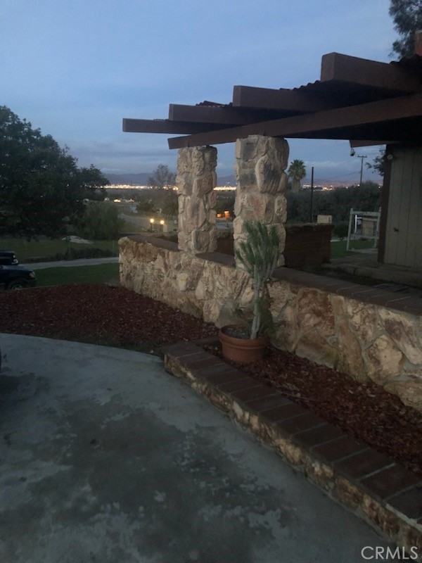 This unique custom home located at 18251 Northstar Ave, Riverside Ca 92508 offers breath taking views across 2.13 acre. Featuring spacious horse stall, ample extra parking, and a huge covered rear patio complete with picnic and barbecue facilities. This property is perfect for both relaxation, family memories, and fun. Located in the middle of this property is detached 3 car garage and workshop, ideal for hobbies or storage. Inside, the kitchen boast beautiful wood-style flooring and opens to a large family room designed for gatherings. Additionally, a separate living room with a charming stone fireplace adds cozy comfort. Two of the three bed rooms are located upstairs, while the main master bedroom with a private bathroom suit is conveniently situated downstairs. Enjoy stunning view of March Airfield from one side of the home and the rolling hills on the other-truly a one-of-a-kind Riverside retreat. This property does have a guest house that was built but never permitted by the county. Conveniently located close to the desirable Riverside Woodcrest neighborhood and only about a mile walk or drive to Citrus High School.