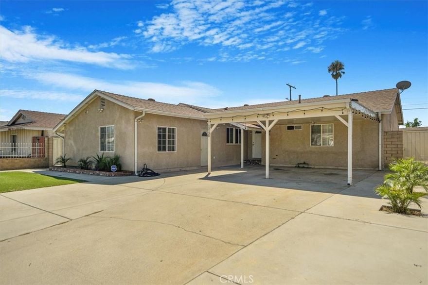 Welcome to this versatile 4-bed, 3-bath home offering 1,402 sq ft of well-designed living space on a generous 6,001 sq ft lot.

Step inside to a bright living room centered around a classic brick fireplace, with recessed lighting and hardwood floors leading into a spacious dining area and galley kitchen featuring rich cabinetry, granite counters, and a full suite of appliances. Freshly painted with recently updated bathrooms, this home is truly move-in ready.

Beyond the main living areas, the property offers tremendous flexibility: the garage has been converted into an addition with permits, creating a self-contained studio with its own bathroom—perfect for extended family, guests, or rental income. Outdoor living is equally inviting, with a large paved patio under a covered pergola strung with lights, low-maintenance turf, and ample driveway parking behind a secure gate.

The home also features a leased solar system that the buyer may continue if preferred, helping to keep utility costs down. Ideally located near major freeways, shopping, churches, and hospitals, this property delivers comfort, convenience, and income potential all in one!