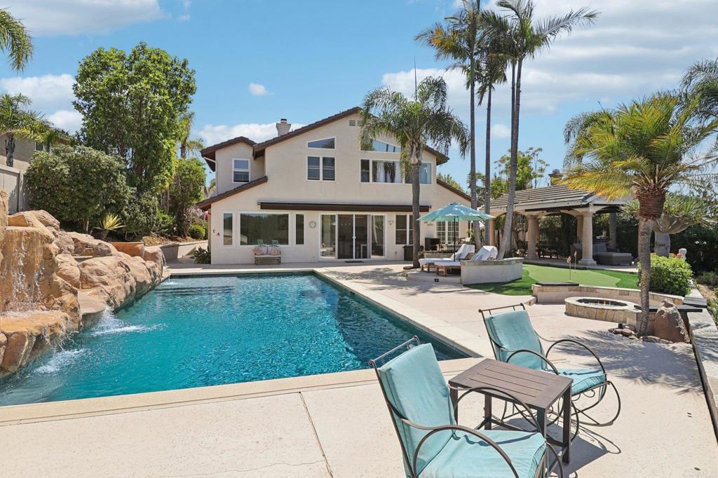 Presenting an exceptional, 3693sf property with private, sunset canyon views! A gorgeous and expansive, western-facing pool home with Owned Solar for the most discerning buyers! A chef's dream remodeled gourmet kitchen with newer, white shaker cabinets and grey quartz countertops. Top of the line stainless steel appliances include a deluxe Sub Zero refrigerator and Viking oven and range. Extra cabinets and countertops, wine rack, beverage station and wine fridge. The open kitchen flows seamlessly into the sun-bathed living room with multiple windows that bring in the light and views. An entertainer’s yard has numerous spaces to enjoy: In addition to the sparkling pool with waterfalls and a slide, there is a putting green, gas fire pit with bench seating and a lovely gazebo with TV and heaters, plus a built-in bbq with fridge and sink. The convenient ground floor bedroom has a full bath ensuite. A laundry room, half bath, 3-car garage with Tesla charger, formal dining and family room with pool table completes the downstairs. A stunning two-story vaulted ceiling entry and updated modern metal railings lead upstairs to the well-appointed primary retreat which has a versatile flex space, beautiful backyard views and walk-in closets. The luxurious primary bathroom has custom cabinetry, dual sinks, a marble vanity, double-headed shower with gorgeous tile accents and a stylish stand alone tub. The additional 3 upstairs bedrooms are each spacious and share an updated bathroom with dual sinks, marble accents and tiled shower (complete with a laundry chute :) Other notable features include a Ring camera doorbell, HVAC with an energy-efficient Ecobee thermostat, Solar Panels for both the home and pool, built-in surround sound speakers in the living room, remote controlled pool cover, sun shades, extra storage under the stairs and in the primary suite. Located in the desirable Poway Unified School District. This is luxurious California indoor/outdoor living at it's best!