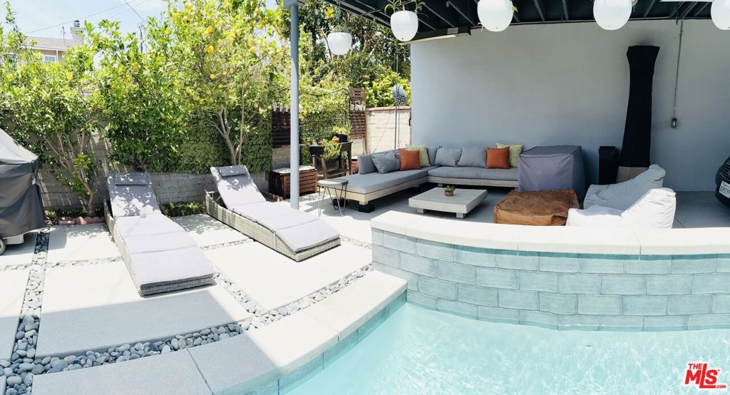Nestled on a quiet, tree-lined street in Los Angeles with a coveted Culver City address, this beautifully updated two-story single-family pool home offers the perfect blend of comfort, style, and convenience. Featuring 3 spacious bedrooms and 3 modern bathrooms, this residence boasts an open floor plan that seamlessly connects the living, dining, and kitchen areas--ideal for both entertaining and everyday living. Enjoy the convenience of a floor plan offering 2 bedrooms and 2 bathrooms on the main level. Step into a bright and inviting living room warmed by a cozy fireplace and enhanced by recessed lighting throughout. The remodeled kitchen is a chef's dream with sleek countertops, stainless steel appliances, and custom cabinetry, opening to a nearby dining area with elegant French doors that lead to the backyard oasis. Upstairs, the luxurious primary bedroom retreat offers a serene escape with ample space, a walk-in closet, and an en-suite bathroom. Outdoors, enjoy the California lifestyle with a sparkling pool, perfect for warm summer days, and plenty of space to relax or entertain. Additional highlights include eco-friendly solar panels, a covered carport, and proximity to local bike trails, parks, and popular restaurants. This exceptional home combines modern upgrades with a prime location, delivering the best of Westside living.