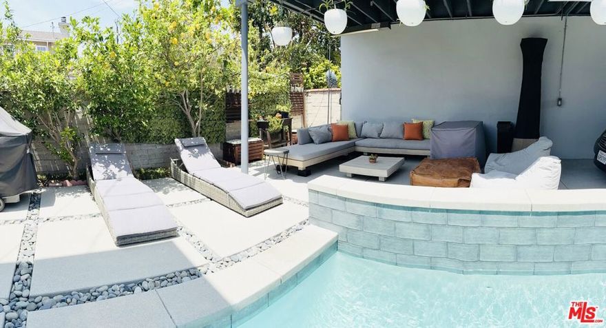 Nestled on a quiet, tree-lined street in Los Angeles with a coveted Culver City address, this beautifully updated two-story single-family pool home offers the perfect blend of comfort, style, and convenience. Featuring 3 spacious bedrooms and 3 modern bathrooms, this residence boasts an open floor plan that seamlessly connects the living, dining, and kitchen areas--ideal for both entertaining and everyday living. Enjoy the convenience of a floor plan offering 2 bedrooms and 2 bathrooms on the main level.  Step into a bright and inviting living room warmed by a cozy fireplace and enhanced by recessed lighting throughout. The remodeled kitchen is a chef's dream with sleek countertops, stainless steel appliances, and custom cabinetry, opening to a nearby dining area with elegant French doors that lead to the backyard oasis. Upstairs, the luxurious primary bedroom retreat offers a serene escape with ample space, a walk-in closet, and an en-suite bathroom. Outdoors, enjoy the California lifestyle with a sparkling pool, perfect for warm summer days, and plenty of space to relax or entertain.  Additional highlights include eco-friendly solar panels, a covered carport, and proximity to local bike trails, parks, and popular restaurants. This exceptional home combines modern upgrades with a prime location, delivering the best of Westside living.  Property is located in Los Angeles with a verified Culver City address.  Buyer to investigate school district zoning.