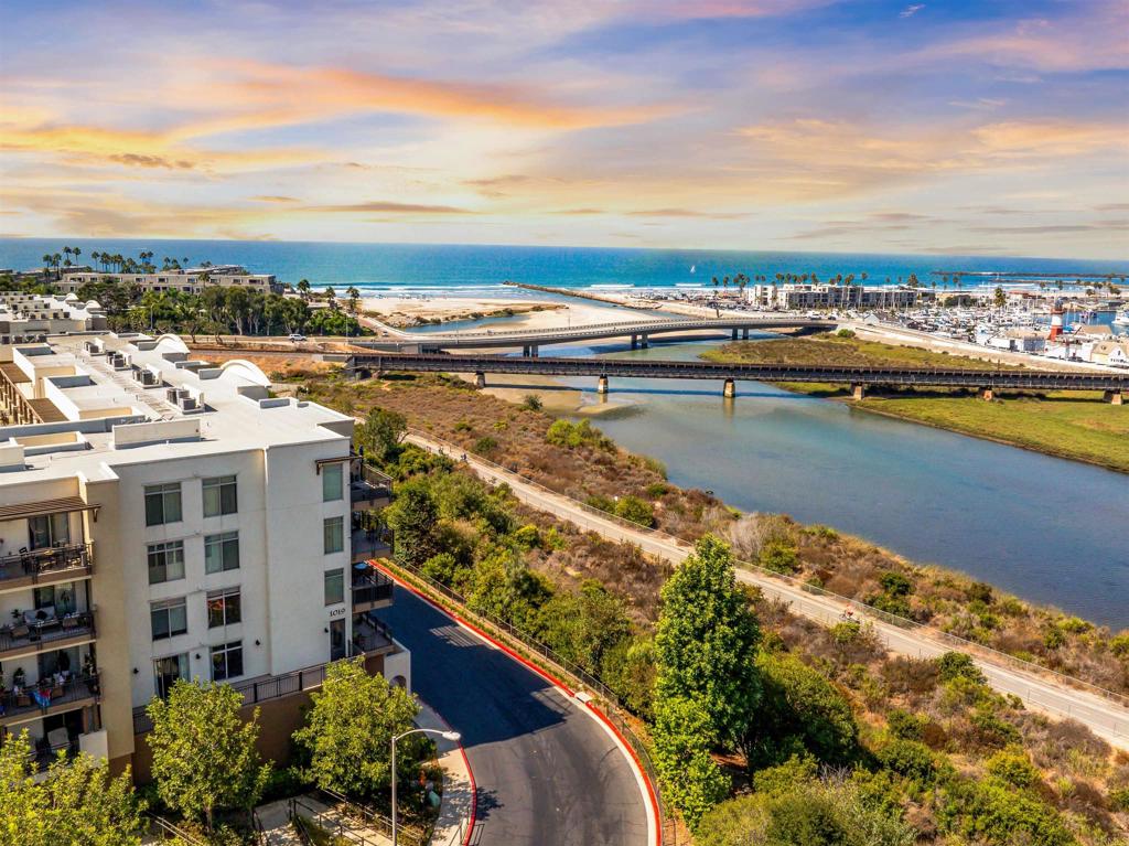 Coming Soon! Welcome to 1019 Costa Pacifica Way, Unit #1110—where coastal living meets modern comfort. Just about 500 Steps to the Sand. This RARE single-level 3-bed, 2-ba condo features a private backdoor entrance, perfect for pet owners or accessible exit. Just walk out the backdoor and the pool, jacuzzi, fitness center and bbq area are a few steps away. Added bonuses include air conditioning, two parking spaces, building elevator, gated entry, and EV charging stations in gated garage. Just a short stroll to the beach and harbor, it’s the perfect mix of seaside lifestyle and everyday convenience. Inside, the open-concept floor plan is filled with natural light from expansive windows overlooking the tropical courtyard. The living, dining, and kitchen areas connect seamlessly, making it a welcoming space for both entertaining and unwinding. The kitchen features modern appliances, sleek countertops, and generous storage, ideal for daily use or weekend hosting. The primary suite offers private balcony access, a walk-in closet, and a spacious & wide walk-in shower. Two additional bedrooms provide flexibility for family, guests, or a home office. First floor access, you’re just steps from the pool, jacuzzi, fitness center, and BBQ area—all the benefits of resort-style living. Easy elevator access takes you directly from the parking garage to your condo. Start your mornings with a coffee at the beach or wind down with a sunset stroll along the harbor. Located west of Coast Highway, this community also borders a scenic 9-mile bike trail and is just minutes from shops, dining, and entertainment.