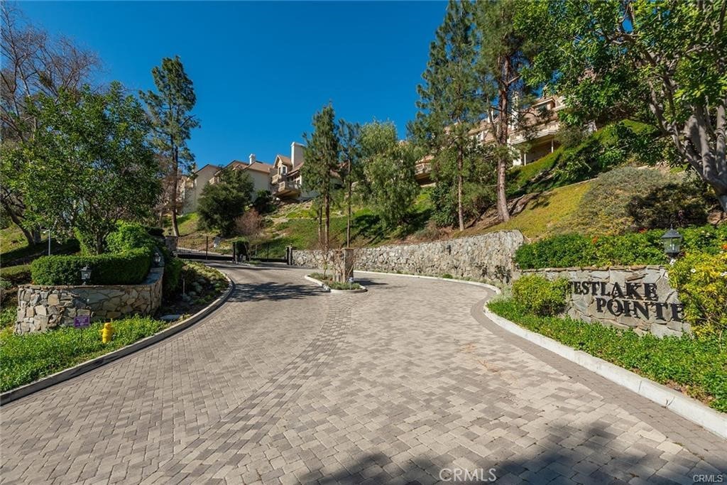 Welcome to this 4-bedroom, 3-bathroom townhome nestled in the desirable and peaceful community of Westlake Pointe, perched above the heart of Westlake Village. Spanning approximately 2,600 square feet, this spacious home offers an abundance of natural light through large windows that showcase serene mountain and treetop views. The living room features a cozy fireplace and opens to a private patio deck—perfect for entertaining or simply unwinding outdoors. You'll also enjoy plenty of outdoor space ideal for gatherings, dining al fresco, or relaxing in the peaceful surroundings. The generously sized kitchen includes ample cabinet storage, a central island, and is ready for your personal touches. The primary suite offers a tranquil retreat with a double vanity, soaking tub, separate shower, and excellent closet space. Additional features include an attached two-car garage, in-unit washer and dryer hookups, and access to the community’s pool and two secure gated entrances. While the home could benefit from some updating, it presents a great opportunity for an owner-user to create their dream space or for an investor seeking their next project. Ideally located near top-rated schools, parks, golf courses, hiking trails, dining, and shopping, this is a rare find in one of Westlake Village’s most sought-after neighborhoods.