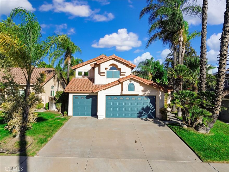 Charming two story Murrieta home featuring 2222 square feet of living space, five bedrooms, and three bathrooms, situated on a spacious 8276 square foot lot with a 3 car garage. This property offers beautiful curb appeal with lush green landscaping and a whole house fan for added comfort. The backyard is perfect for relaxing or entertaining, with a covered patio leading to an inviting in ground pool and spa, your own private oasis. Upon entering, the sitting and dining areas feature wood flooring that flows seamlessly throughout, complemented by abundant windows and a sliding glass door that fills the space with natural light. Straight ahead, a staircase, as well as the hallway leading to spacious living room and kitchen. This living area features a unique design, boasting a ceiling fan, a wood burning fireplace and an additional dining area. Experience indoor outdoor living in the dining area, which opens to backyard through a sliding glass door with views of the pool. The kitchen features granite countertops, white cabinets with ample storage, and bar seating for two. Recessed lighting and a window beyond the sink fill the space with natural light, while stainless steel appliances including a 4 burner stove with a center warmer, oven, and dishwasher add a modern touch. This well designed layout also includes a convenient downstairs full bathroom and a bedroom featuring a window and a closet with sliding mirror doors. Venturing upstairs, you will find vinyl wood flooring throughout, the master, 3 additional bedrooms and a linen cabinet at the top of the stairs. The master bedroom features wood flooring and vaulted ceilings, with a sliding glass door that opens to a private balcony overlooking the backyard oasis. An attached bathroom features a dual sink vanity, jetted soaking bathtub, large walk-in shower, and the closet. The 3 additional bedrooms provide ample comfort, each featuring vinyl wood flooring, windows, vaulted ceilings and closets. The hallway bathroom offers a dual sink vanity, tile floors, and a shower/tub combo. Outside, the backyard is your own personal paradise. Enjoy entertaining under the covered patio or unwind in the stunning custom rock like in ground pool, complete with a slide, spa, and waterfall accents. The lush palm trees, and low maintenance landscaping create a serene environment. The home's location is convenient, with shopping centers, freeways, and highways nearby, offering a perfect blend of comfort and accessibility.