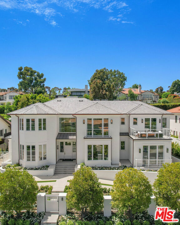 Nestled in the prestigious Riviera neighborhood of Pacific Palisades, this newly completed residence epitomizes sophisticated living on 16,186 square feet of luxuriant, resort-like grounds. Moments from the renowned Riviera Country Club, the vibrant Palisades Village, and a short drive to Will Rogers State Beach, this home offers an exceptional Westside lifestyle. Designed by acclaimed architect Ken Ungar with interiors by KES Design Studio, the Traditional architecture is enriched by custom millwork, exquisite natural stone, and meticulously curated finishes. While state-of-the-art home tech -- an elevator, Savant home automation, surround sound, a security system with cameras, and Enphase solar panels -- ensures everyday convenience. Enter the grand two-story foyer and experience 10,603 square feet of light-filled living spaces, effortlessly balancing grandeur with intimate comfort. Multiple living rooms, an inspiring office, and a formal dining room with a coffered ceiling and adjacent butler's pantry set the stage for sophistication, while the gourmet kitchen boasts marble surfaces, top-of-the-line Wolf appliances, custom cabinetry, and a charming breakfast nook overlooking the garden. The residence has seven spacious en suite bedrooms, inclusive of the impressive primary suite. This haven of tranquility inspires total relaxation with a cozy fireplace, private balcony, dual custom closets, and a luxurious bathroom with book-matched marble accents. The lower level is designed for ultimate entertainment, complete with a lounge and wet bar, a wine tasting room and cellar, a theater, gym, and direct access to the subterranean 4-car garage. Enveloped by lush, impeccably manicured landscaping, the resort-style backyard is a private oasis for unforgettable gatherings or quiet moments. Revel in the California sunshine by the sparkling pool or elevated sun deck, host al fresco dinners from the outdoor kitchen and pergola-covered dining area, and unwind in the spa or by one of two outdoor fireplaces while taking in stunning sunset views. Additionally, the residence is well-appointed for caretakers and staff with separate service quarters, a staff entrance, a service kitchen, and a dual W/D laundry room. Supremely positioned and expertly equipped, this unparalleled Riviera residence invites an exceptional living experience in the Westside's most coveted neighborhood.