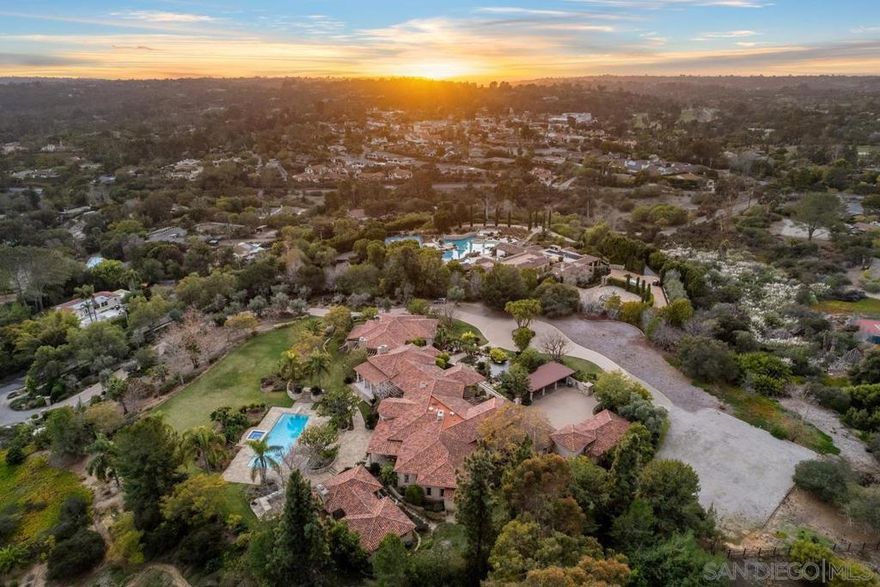 Set on 6 Expansive VIEW Acres, 6372 Las Colinas is located within the prestigious Rancho Santa Fe Covenant, this exceptional Custom-Built Estate offers unmatched Privacy & Tranquility. Every facet of this residence was precisely curated to evoke a sense of awe. The meticulously maintained grounds feature a long olive tree-lined driveway and include a variety of mature citrus and fruit trees. Five-Star resort-style ambiance with a stunning, classic rectangular pool, complete with a stylish Cabana, perfect for relaxation and entertainment. ALL single-level living boasts generous living spaces seamlessly blending indoor/outdoor living featuring spacious bedrooms, an executive office, and a versatile game/kids lounge, along with a Detached Guest Casita for added privacy and comfort. Car enthusiasts will appreciate the ample 6-car garage space, set within a grand motor court. Located in a highly desirable area of the Covenant, the property provides easy access to 60 miles of private equestrian/walking trails and within Roger Rowe School District. This estate is not only a testament to luxury living but also a serene retreat that promises a lifestyle of exceptional comfort and prestige.