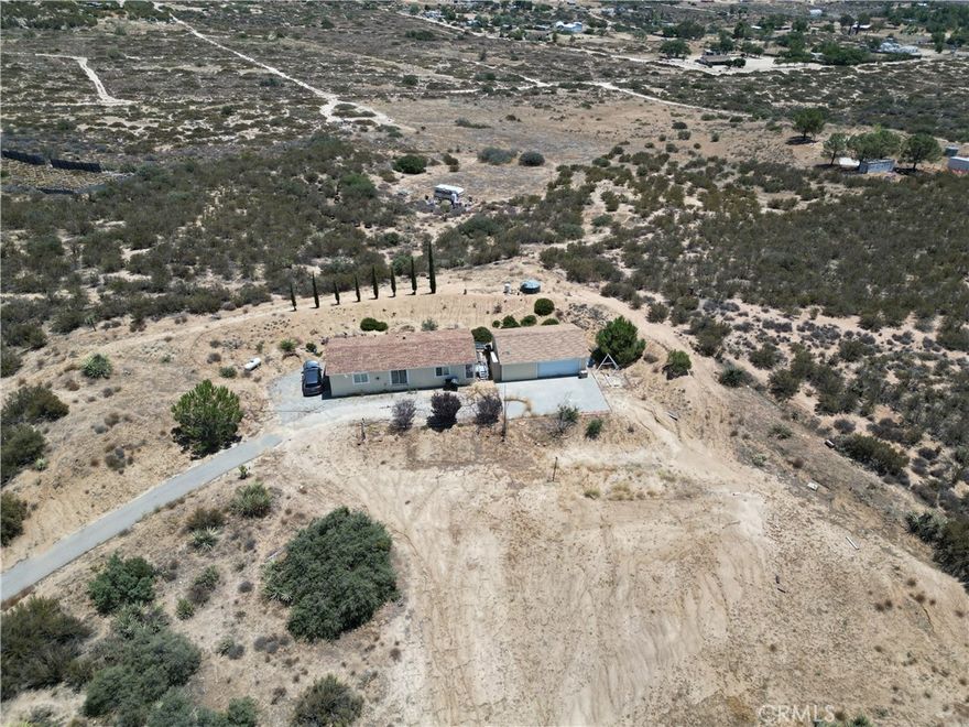 This home needs some TLC and completion of ongoing renovations. Ideal for buyers seeking a project with strong upside. Perfect blend of comfort, privacy, and versatility on 5.35 acres of land. 3-bedroom, 2-bathroom manufactured home is ideally situated to take full advantage of stunning panoramic views of the valley and surrounding town. Currently scheduled to get renovated with New Paint and New Flooring. 

The property also includes a detached two-car garage with an extra bay for a third vehicle, workshop, or storage space. Fully fenced and surrounded by 360-degree views, this peaceful and private setting offers a unique opportunity to enjoy serene country living with convenience and comfort. Just minutes from local shops and services. Endless potential!