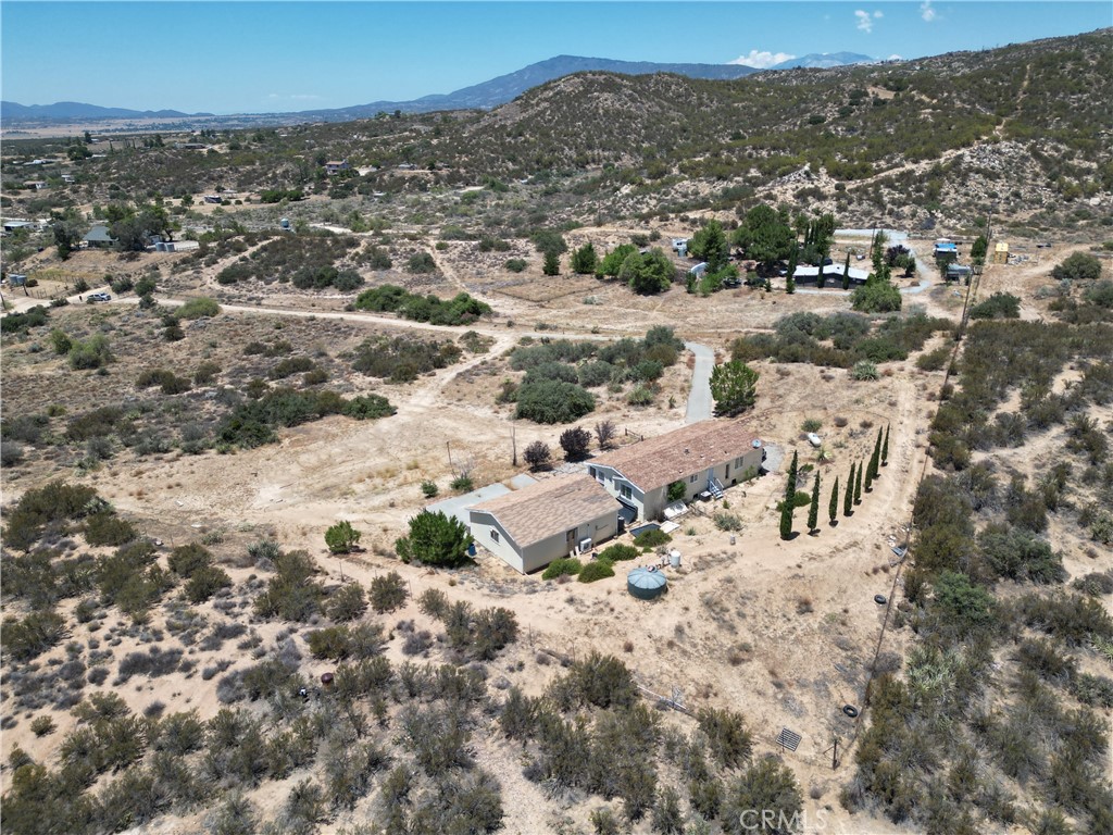 This home needs some TLC and completion of ongoing renovations. Ideal for buyers seeking a project with strong upside. Perfect blend of comfort, privacy, and versatility on 5.35 acres of land. 3-bedroom, 2-bathroom manufactured home is ideally situated to take full advantage of stunning panoramic views of the valley and surrounding town. Currently scheduled to get renovated with New Paint and New Flooring.
The property also includes a detached two-car garage with an extra bay for a third vehicle, workshop, or storage space. Fully fenced and surrounded by 360-degree views, this peaceful and private setting offers a unique opportunity to enjoy serene country living with convenience and comfort. Just minutes from local shops and services. Endless potential!