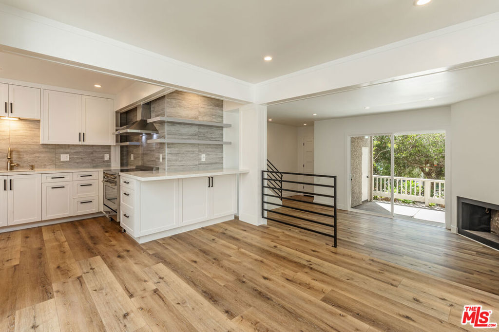 This fully renovated 2-bedroom, 2.5-bathroom townhome in the gated Malibu Villas blends modern design with coastal charm. Bright, open interiors feature wide-plank wood flooring, vaulted ceilings, and a cozy fireplace, flowing seamlessly to multiple outdoor spaces surrounded by lush greenery ocean views. The recently updated chef's kitchen boasts quartz countertops, custom cabinetry, and stainless-steel appliances. Upstairs, the primary suite offers vaulted ceilings, generous closet space, and private balcony access, while secondary bedrooms provide versatility for guests or a home office. Malibu Villas residents enjoy a pool, spa, clubhouse, and gated entry, all just minutes from Paradise Cove, Zuma Beach, and Malibu Country Mart.
