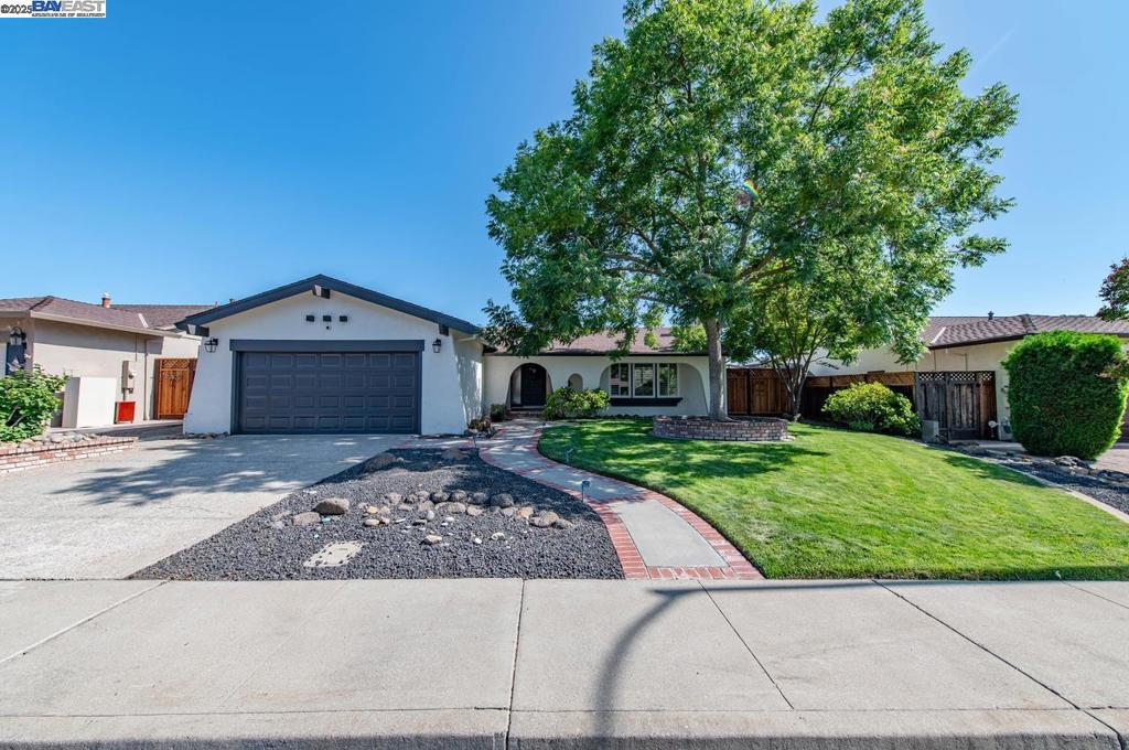 Charming and thoughtfully updated, this single-story 3-bedroom, 2-bathroom home is located in the highly desirable Tempo neighborhood of South Livermore. From the moment you arrive, you’ll appreciate the home’s inviting curb appeal and well-maintained exterior. Enter through a charming arched entryway and step into a bright, flowing floor plan that seamlessly connects the cozy living room with the adjacent dining area—an ideal layout for both everyday living and entertaining. The updated kitchen features crisp white cabinetry, elegant stone countertops, and matching white appliances, all bathed in natural light and offering a lovely view of the backyard. The spacious primary suite includes large windows with custom shutters and a beautifully updated ensuite bathroom. Step outside into your own private retreat: a sparkling in-ground pool and spa, expansive patio, and serene garden views make this backyard perfect for relaxing or entertaining. A large bonus storage shed on the side yard offers additional versatility. This turnkey home offers a peaceful, easy-living lifestyle with thoughtful upgrades throughout. Located within top-rated school boundaries and just minutes from vibrant downtown Livermore, local parks, wineries, and South Bay commute routes—don’t miss the opportunity!