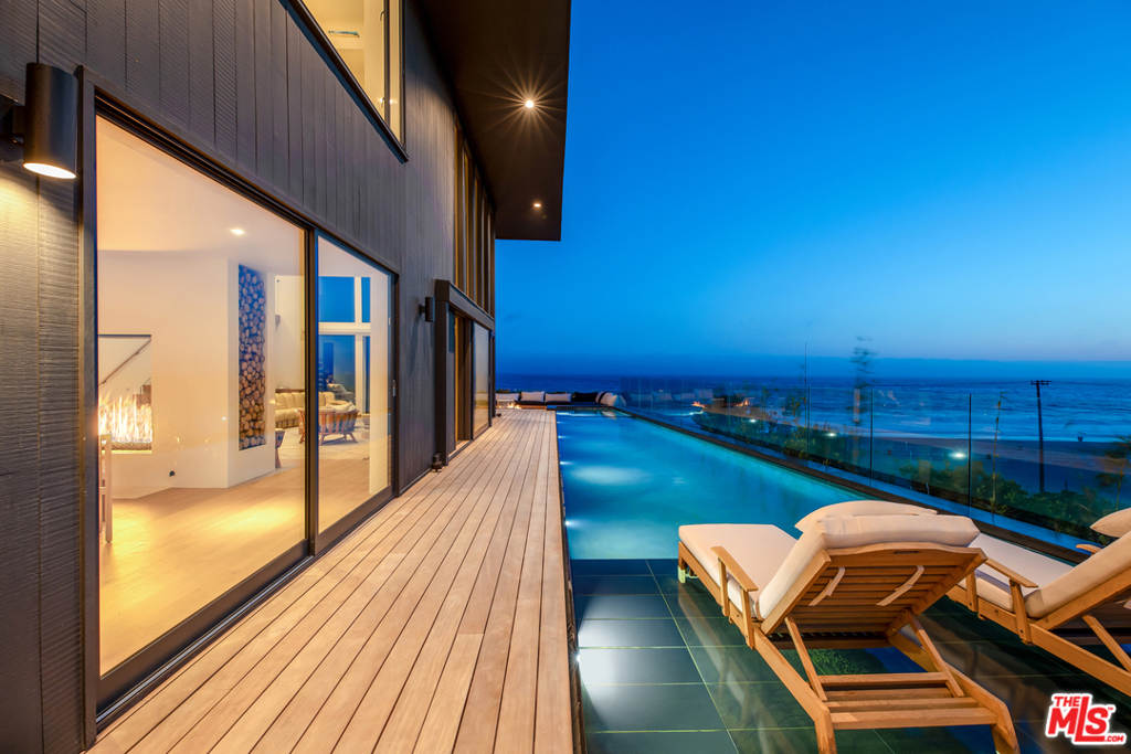 Breathtaking Malibu Zuma Beach Bluff Top contemporary, 3+3.5, plus gym. Emotion evoking whitewater and sunset views above Zuma looking down the Broad Beach coastline from house and pool. Private steps to surf or stroll to Trancas Market. 20 high ceilings with double volume glass walls surround the living room, a 5x5 see-through fireplace dividing the great room into a dining room, family room, and kitchen. Massive entire top floor master includes huge views, wet bar, master bath with views, vanity, stone shower, and a romantic bathtub with a fireplace and lounge area, gym, and yoga rooftop patio with views to Pt Dume. Two additional en suite bedrooms, one ocean, and one courtyard view, an interior courtyard- just off the great room. Full BBQ kitchen, sound system, and Control Four automation. WWW.BELZBERGDD.COM