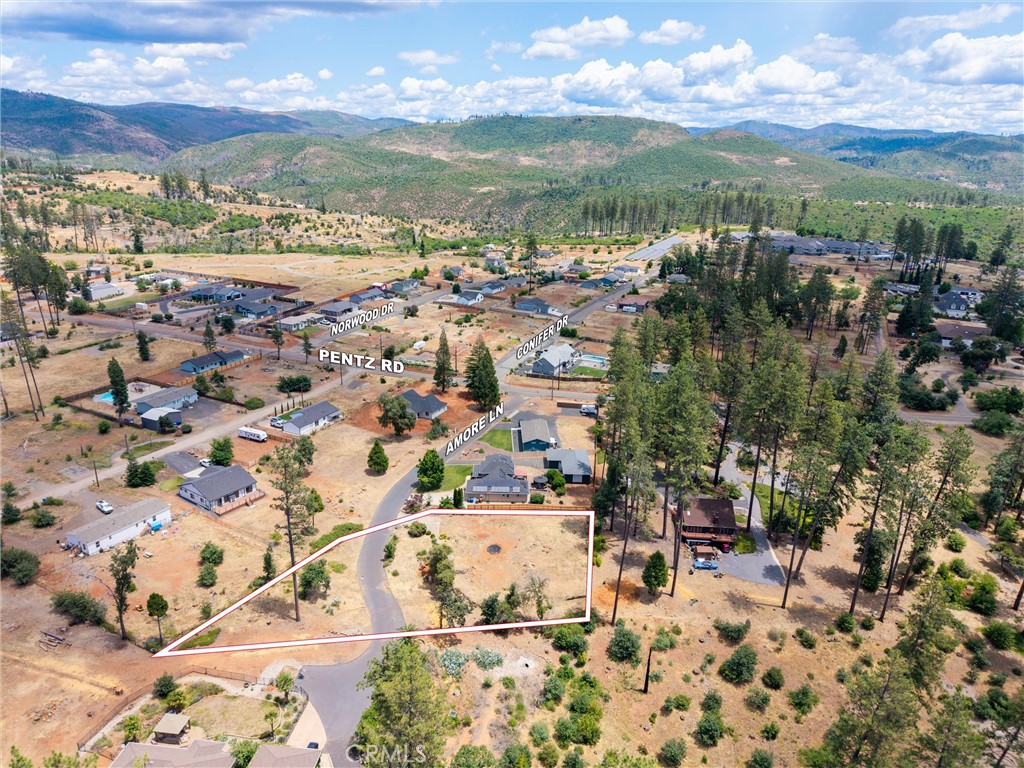 Embrace refined country living on this rare .65-acre parcel at the end of a quiet, paved cul-de-sac. Surrounded by beautifully constructed custom homes, this private oasis offers a level, ready-to-build canvas with existing concrete apron, driveway, and pathway from a former home. Public water is available, and the septic tank is intact but the leach lines need to be replaced (buyer to verify). Gently sloped and full of possibility, the property invites you to design your ideal residence—complete with garage, shop, garden, or casita. Located in a vibrant rebuilding community, this lot delivers both peace and promise. Don’t miss your chance to build your custom retreat in this coveted East-Paradise enclave!
